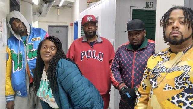 Five rappers collaborating in studio for cypher